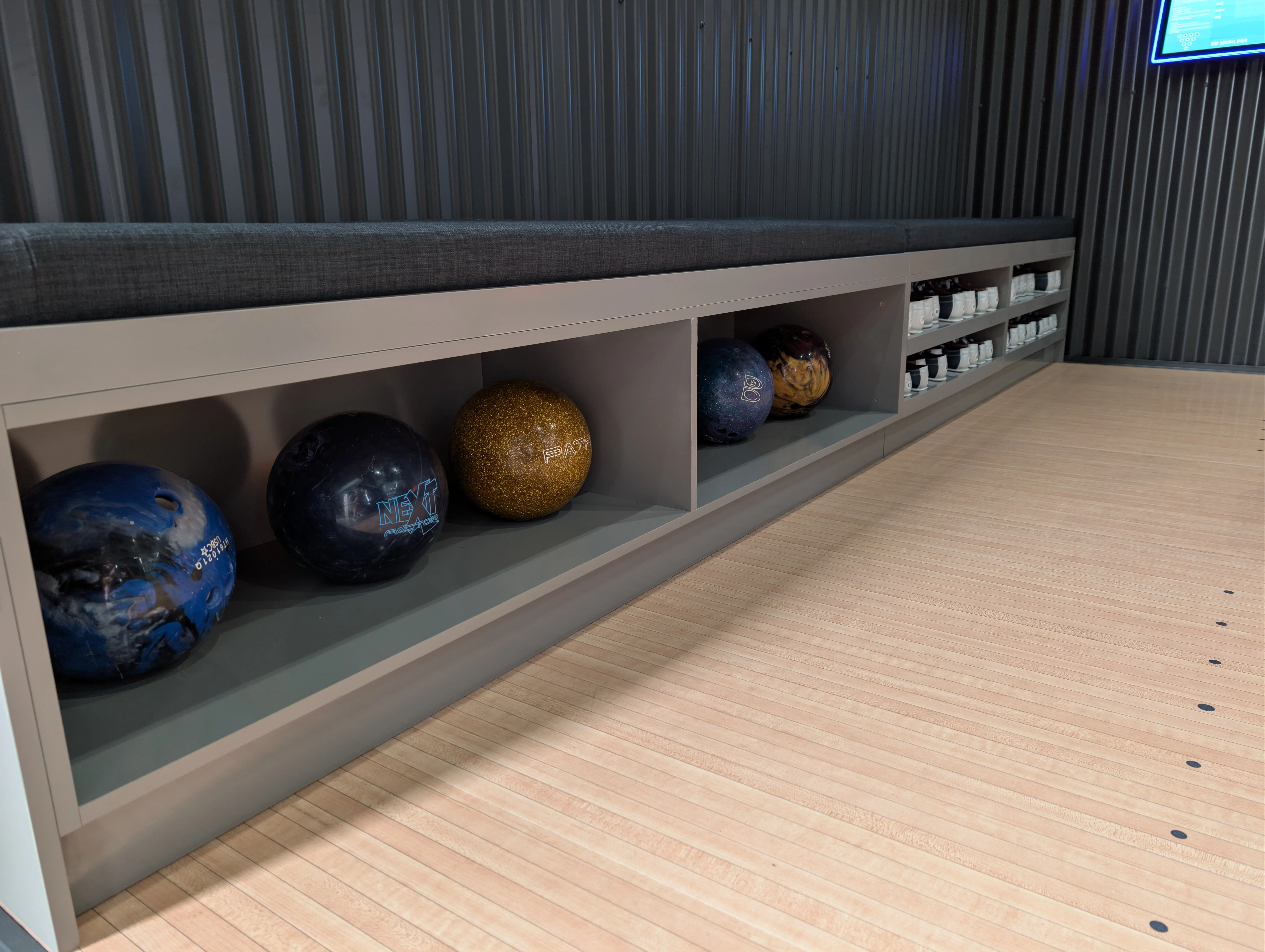 Bench seating and storage beside a private bowling lane