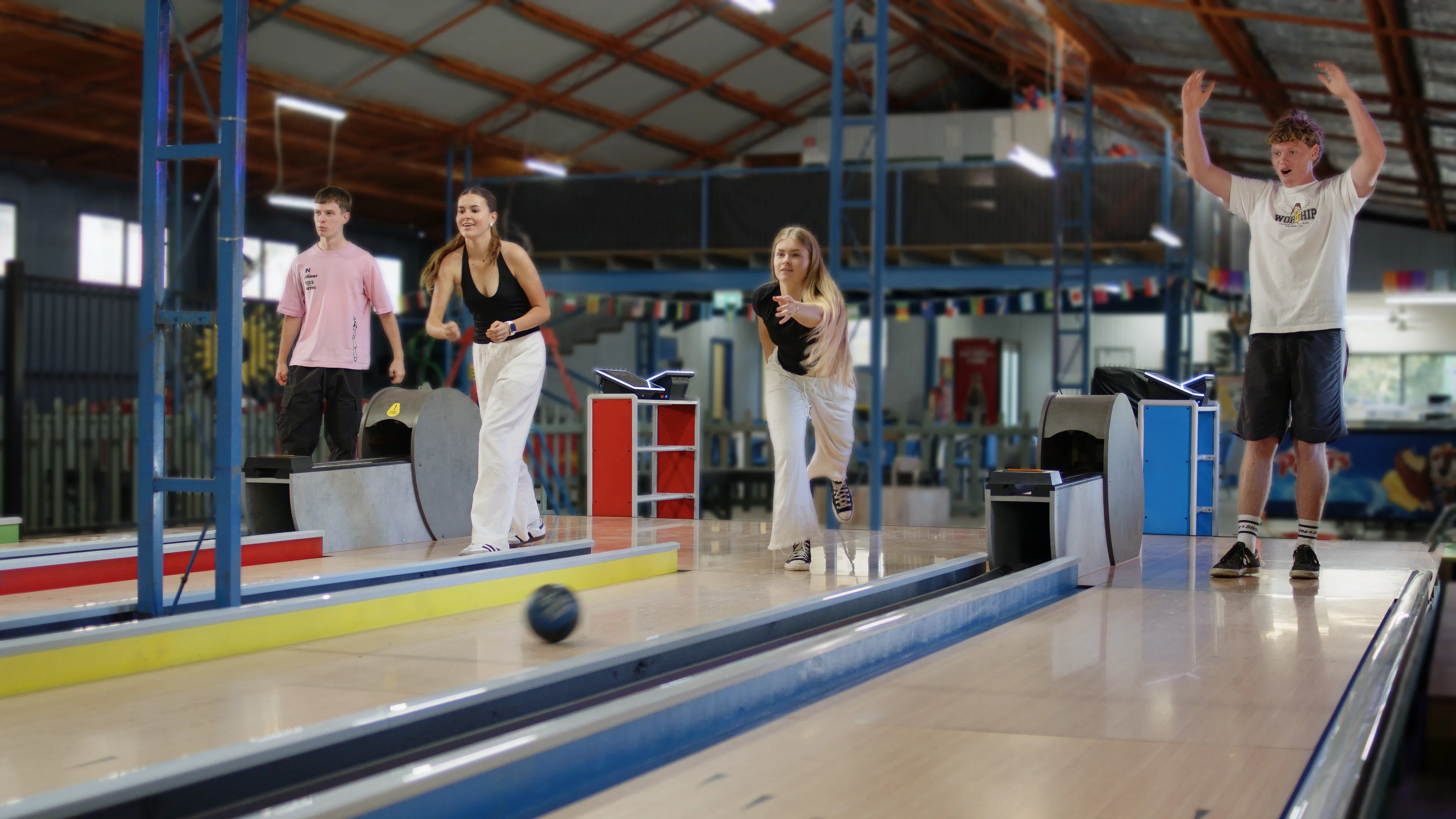 Group of friends having fun bowling together on a LaneCraft lane