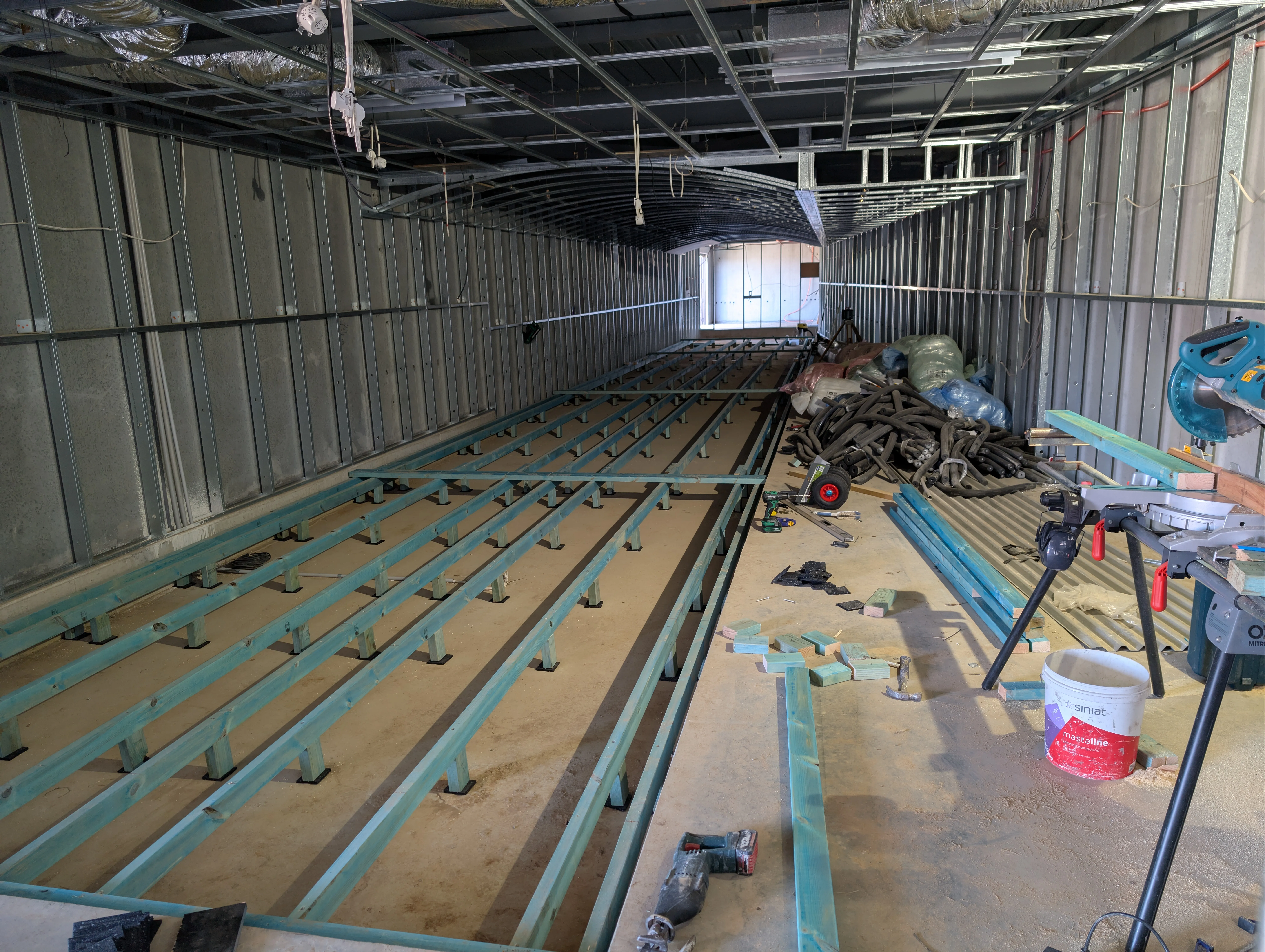 Timber subfloor joists being installed for precision lane levelling