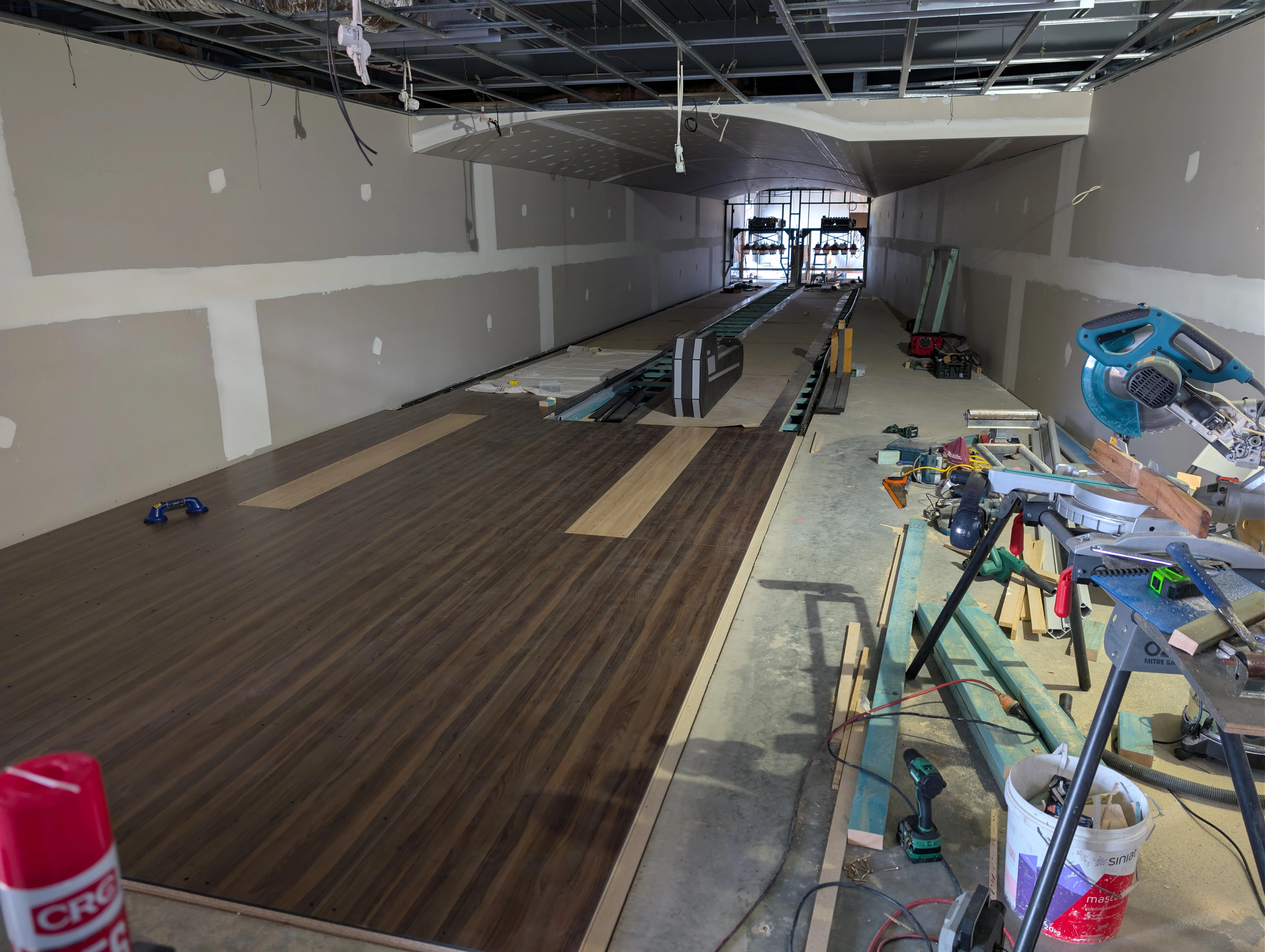 Two bowling lanes under construction with timber surface being laid