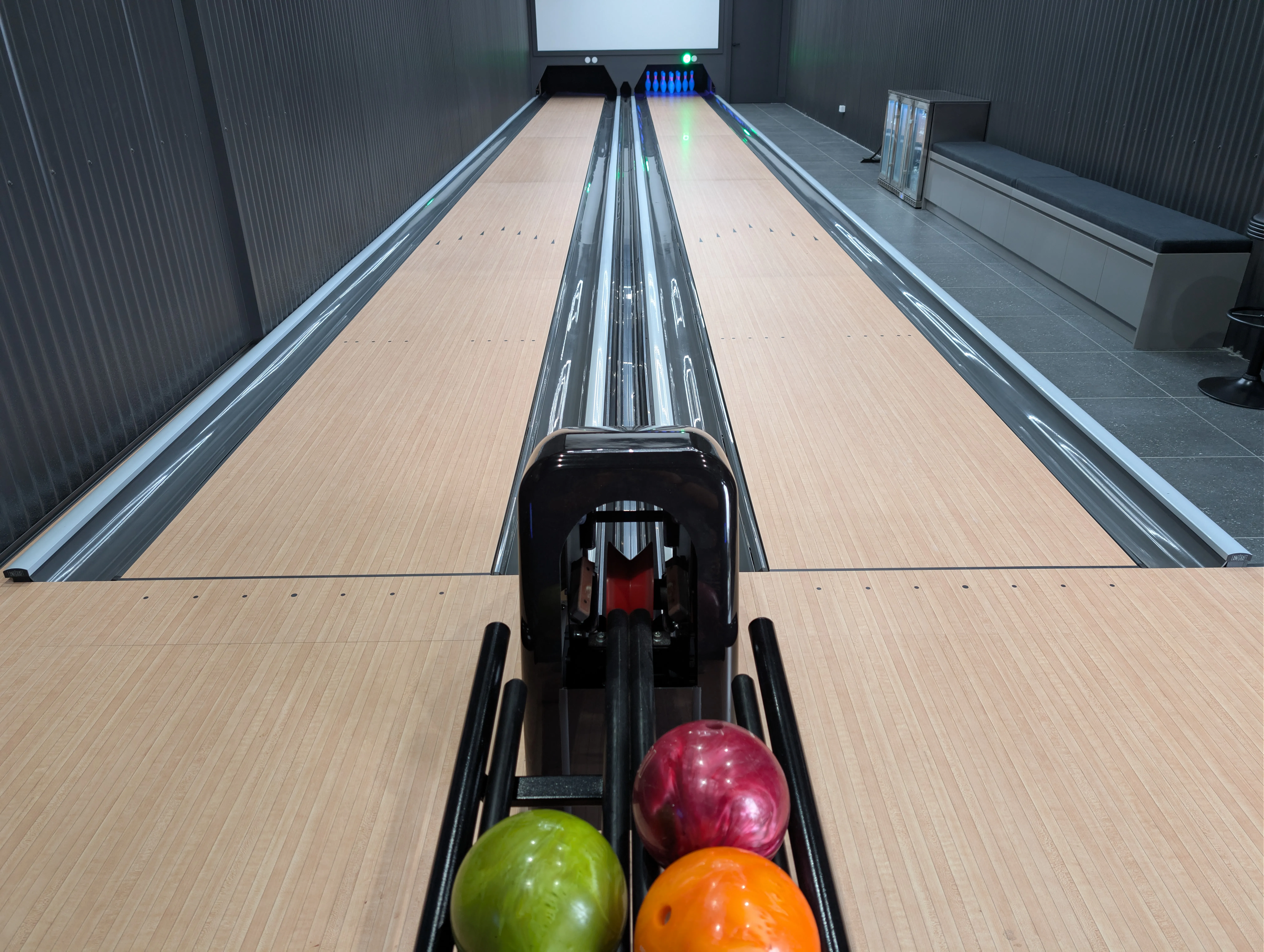 View down a finished two-lane Tenpin installation, showing the playing length from the approach to the pins