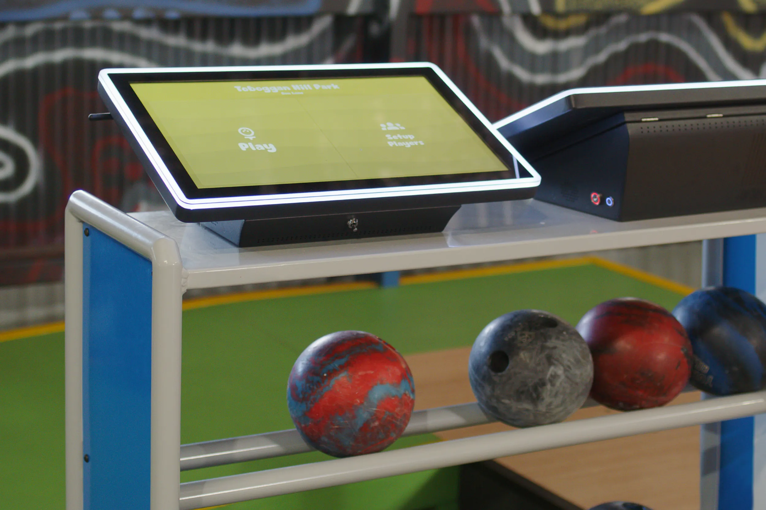Custom LaneCraft touchscreen scoring console installed at the approach end of a lane