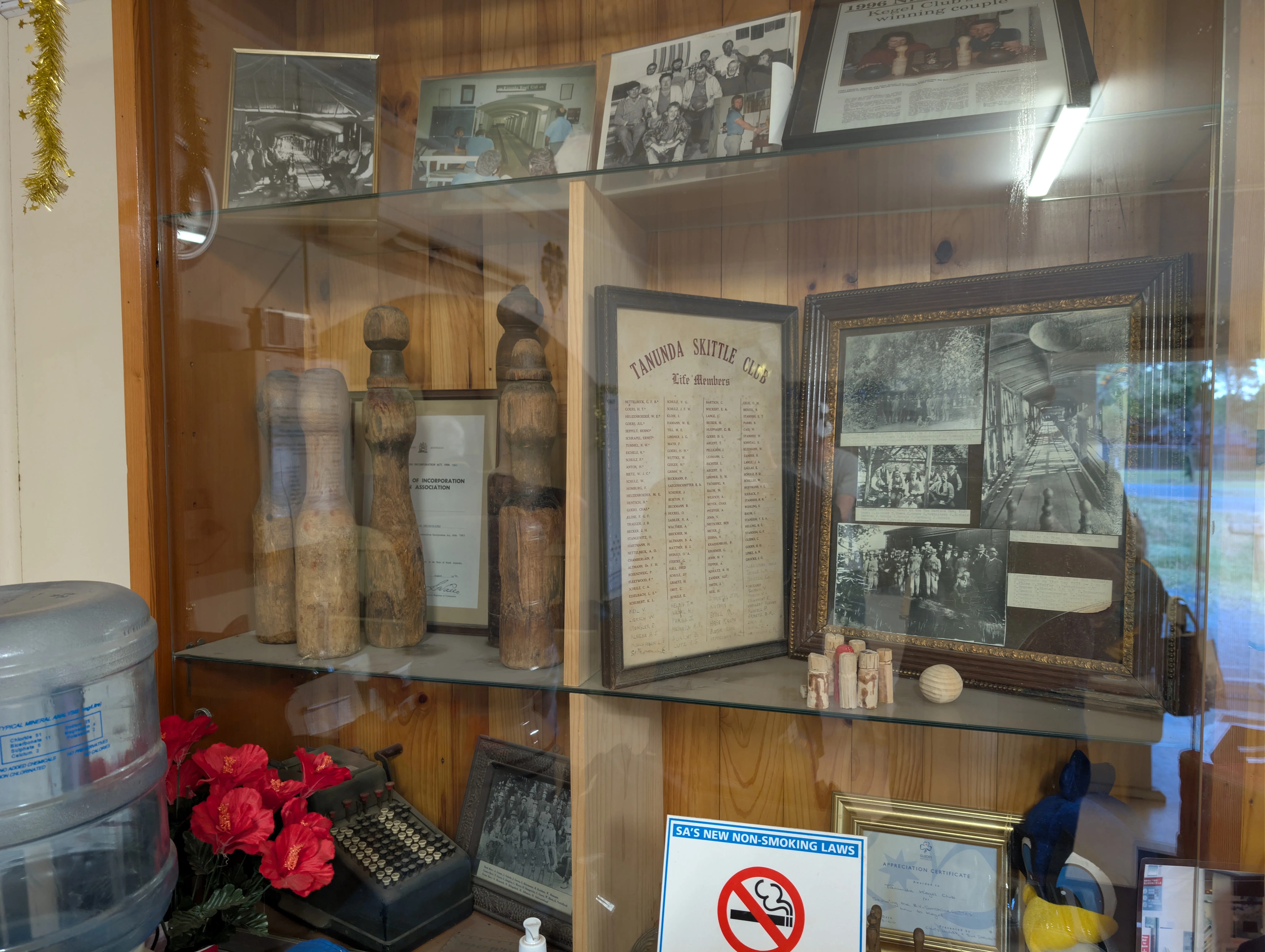 Display cabinet at the Tanunda Kegel Club showing antique wooden pins and the original Tanunda Skittle Club membership document